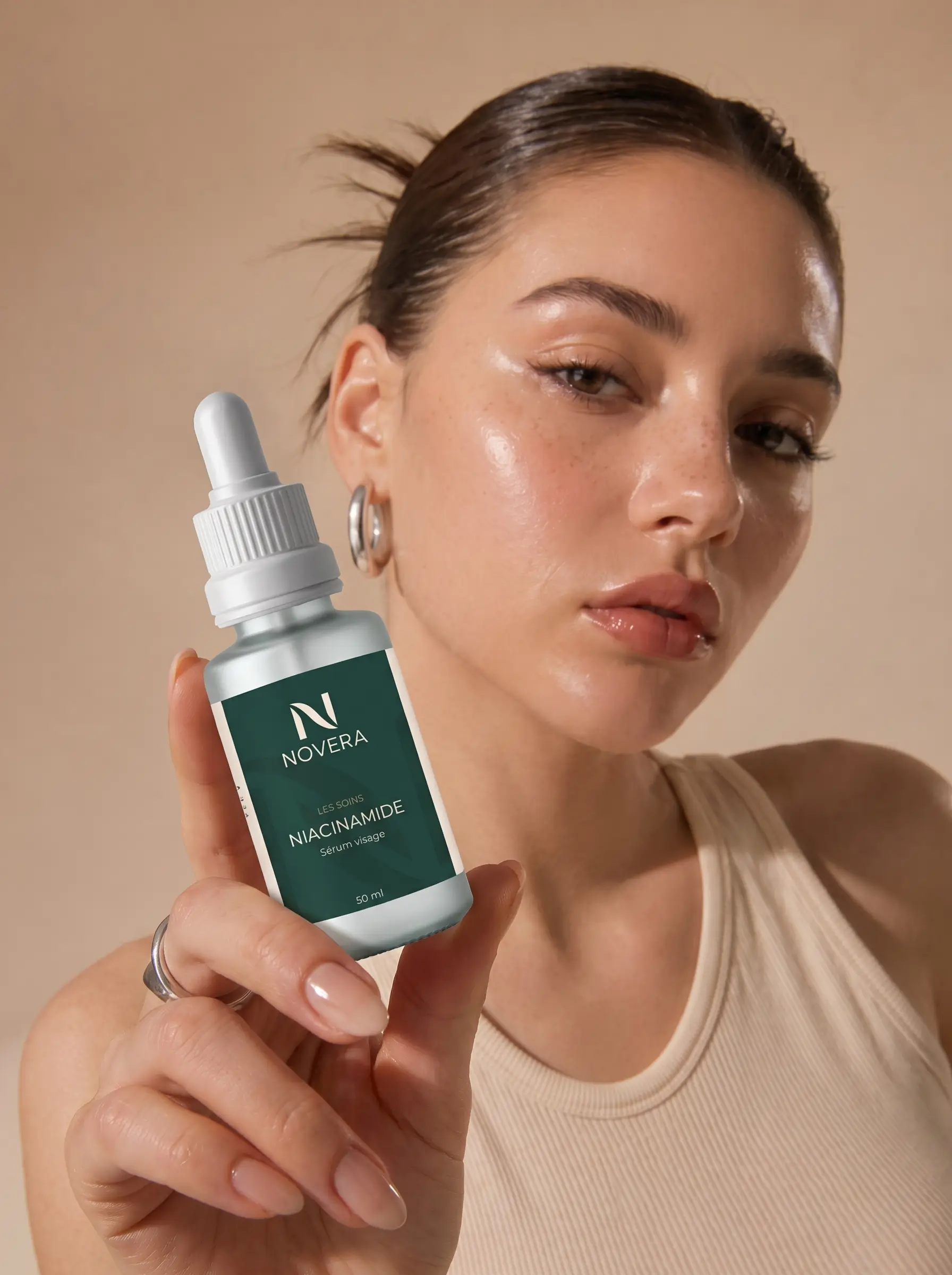 Portrait de campagne NOVERA : une femme tenant le sérum niacinamide